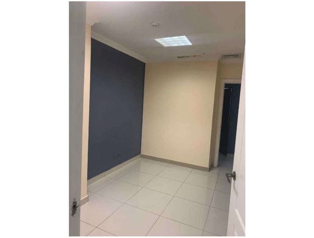 Contemporary interior with accent blue wall, tile floor and lighting in Costa del Este office PH Top Tower