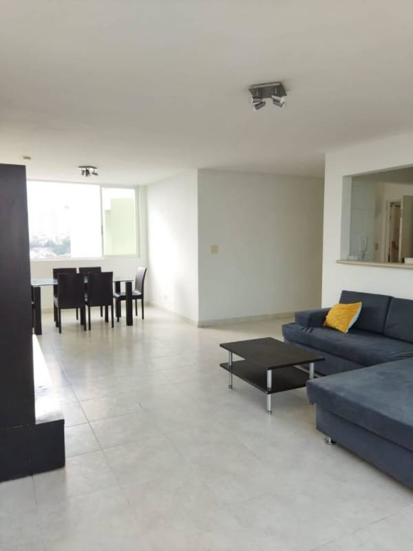 Modern open plan living dining area with sectional sofa and windows PH Majestic Garden Panama