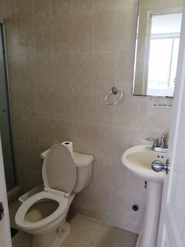 Modern bathroom tiled walls pedestal sink walk-in shower in PH Majestic Garden Panama City