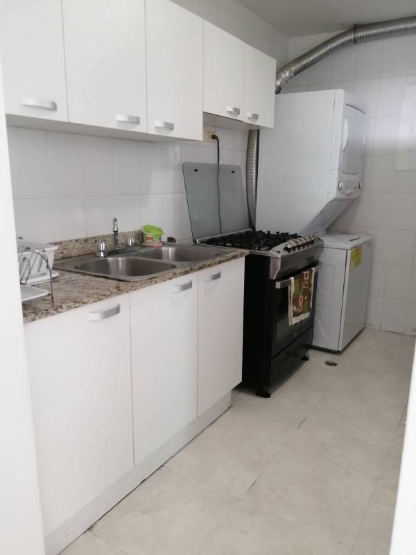 Kitchen with granite countertops gas stove washer dryer in PH Majestic Garden Edison Park Panama City