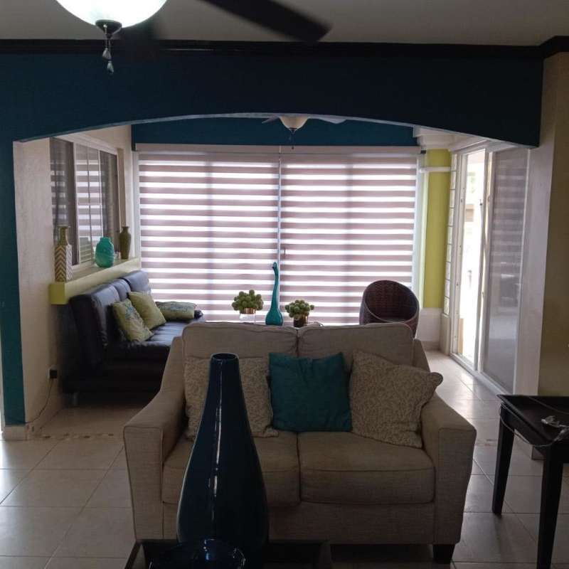 Octagonal outdoor jacuzzi spa with blue mosaic tiles in private backyard Brisas del Golf Panama