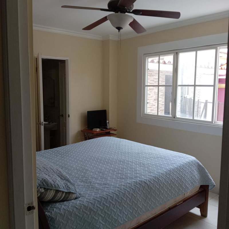 Bedroom with light blue bedding, ensuite, AC and fan Brisas del Golf Panama City