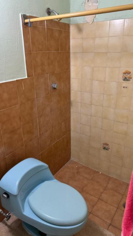 Empty bedroom with light tile floors, ceiling tiles, burgundy curtains near El Dorado Mall Panama