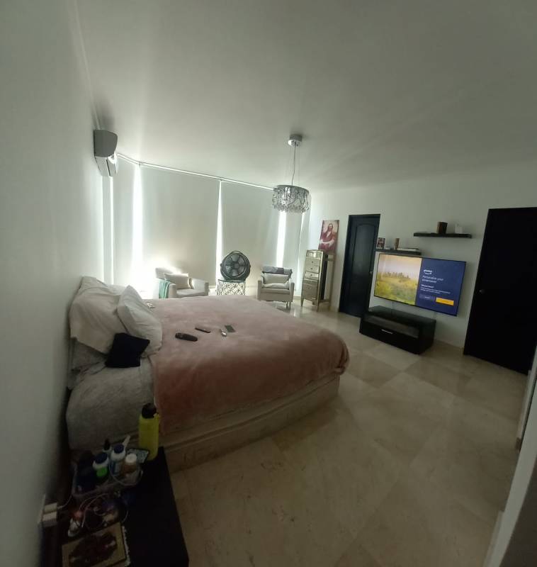 Large living room with sectional sofa, light blue walls, recessed lighting PH Bahía Esmeralda Panama Marbella