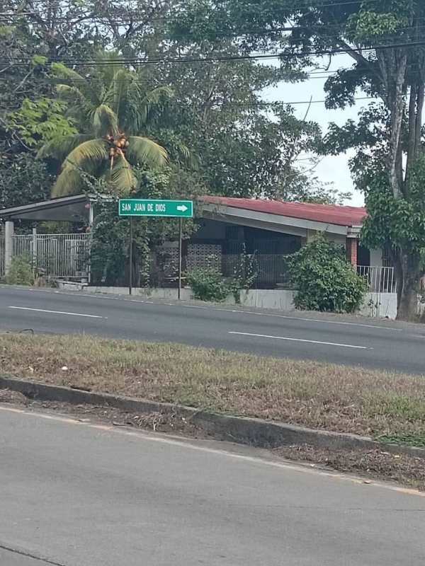 Suburban house with red roof and lush vegetation adjacent Las Cumbres 1 hectare land plot Panama