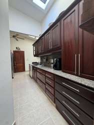 Private rectangular swimming pool with lush garden in Canta Rana luxury house Chitré Panama for sale