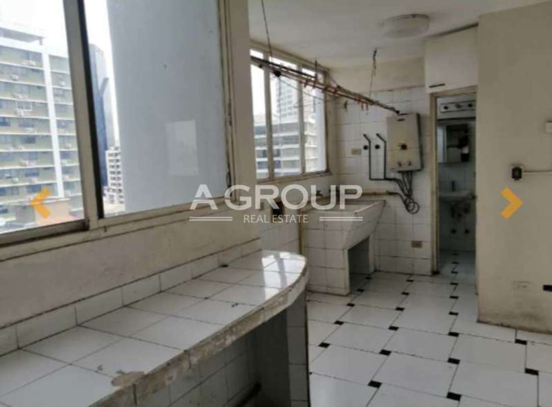 Laundry room with sink, countertop, windows city view in apartment Torres del Pacífico Panama