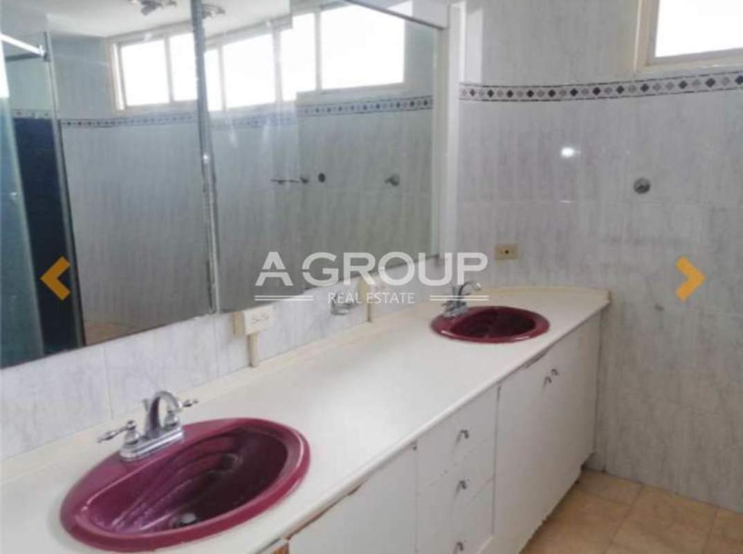 Bathroom with double sinks, large mirror and tile at Torres del Pacífico Panama