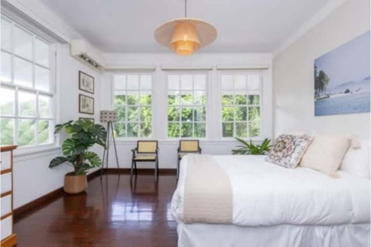 Historic home kitchen with wooden cabinets, granite counters, stainless steel appliances and dining area in Cerro Ancon Panama