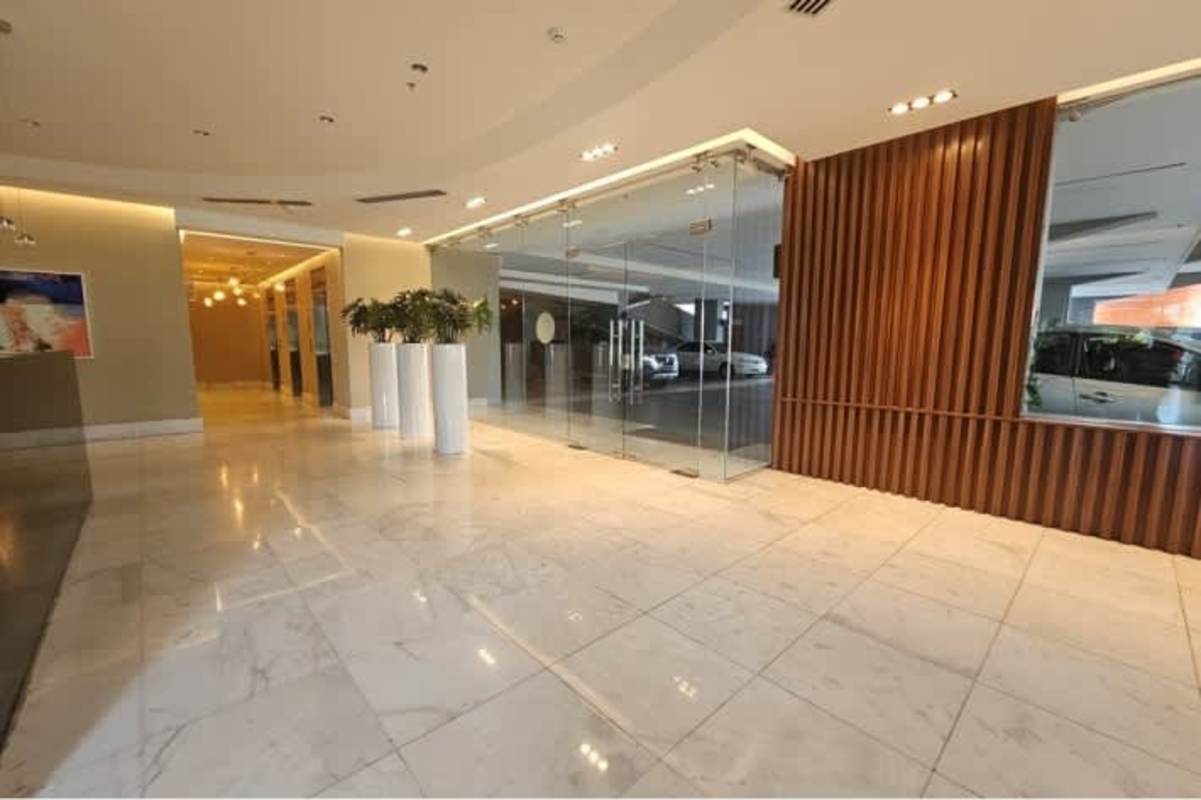 Elegant modern office lobby marble floors glass doors indoor plants Panama