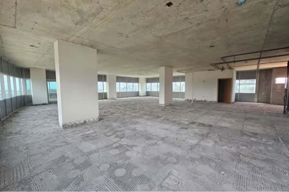 Rustic unfinished commercial interior large windows mountain and city views Santa María