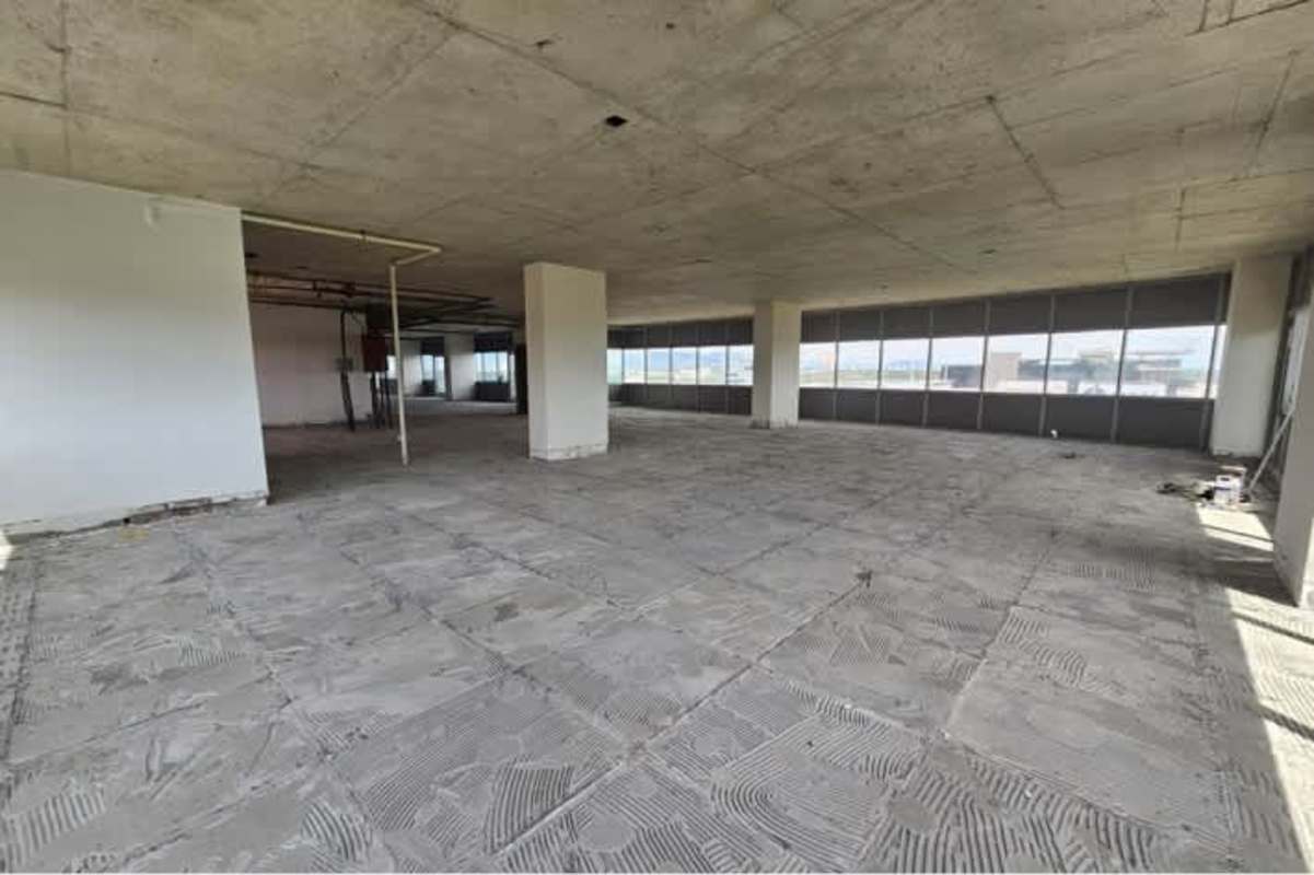 Grey shell office with concrete floor and ceiling large glass windows Santa María Panama