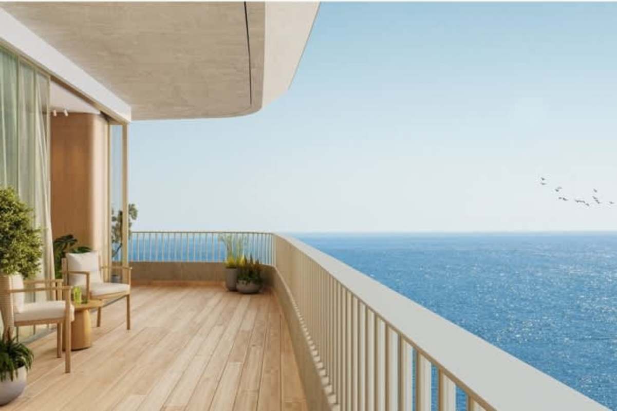Oceanfront balcony with wood flooring, ocean views and modern glass railing