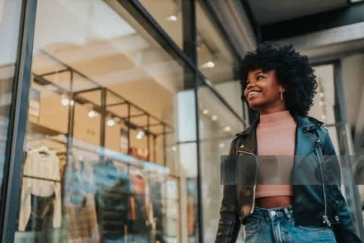 Retail storefront with large glass windows and woman walking past in Costa del Este plaza