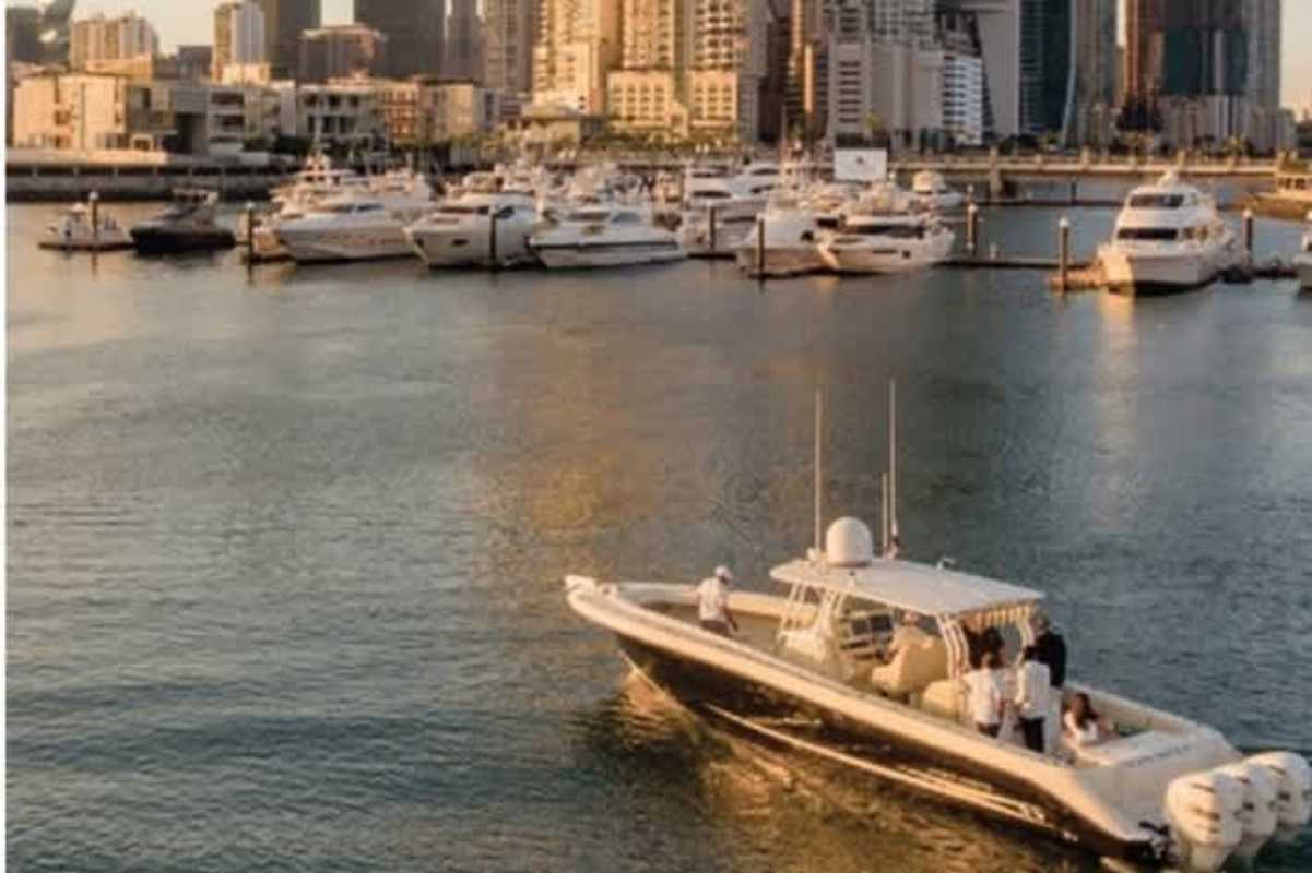 Luxury yachts cruising near marina community at Ocean Reef Islands with skyline in view, Panama