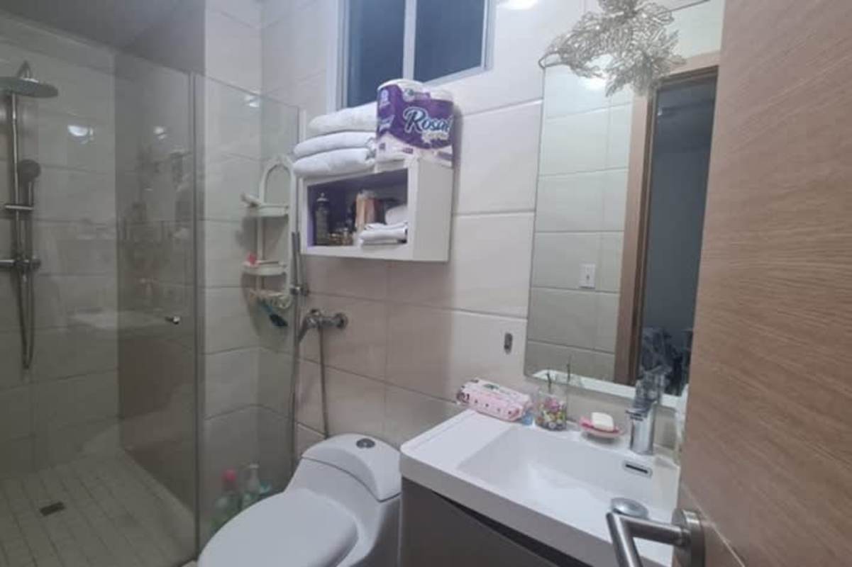 Modern tiled bathroom with glass shower enclosure and vanity in PH Vía España Panama