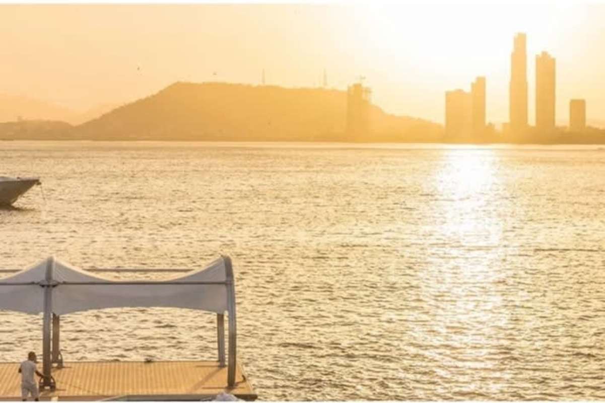 Sunset over private dock and city skyline from Ocean Reef Islands Panama