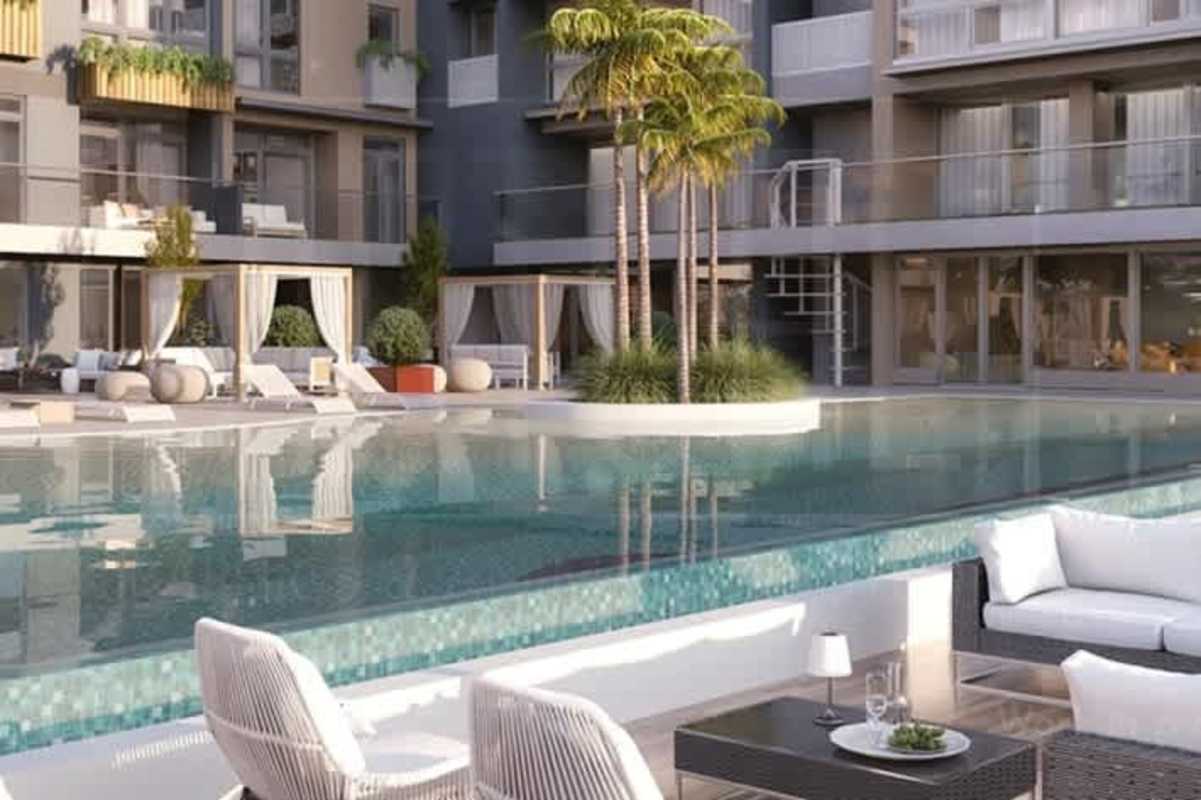 Resort-inspired swimming pool deck with cabanas and palm trees at Oceana Residences Santa María