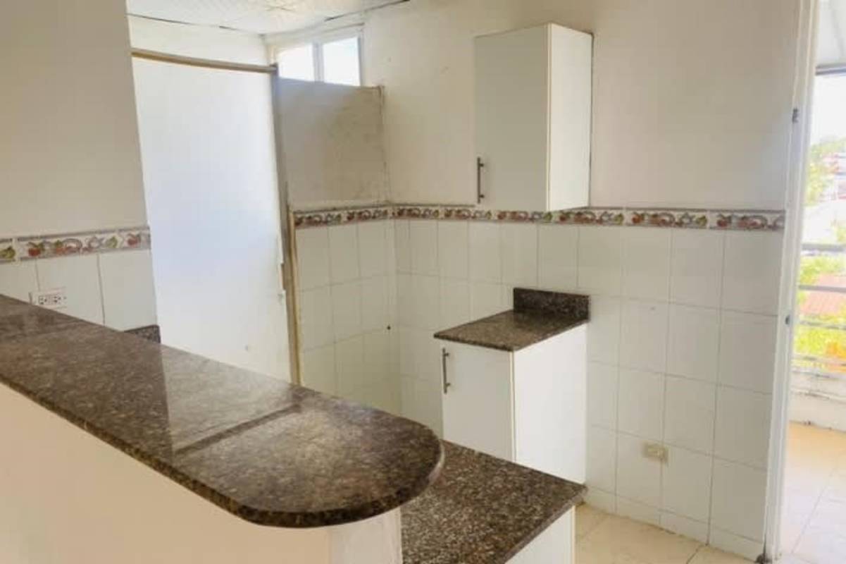 Small kitchen with granite countertop fruit-patterned tiles PH Mystic Town Pedregal Panama