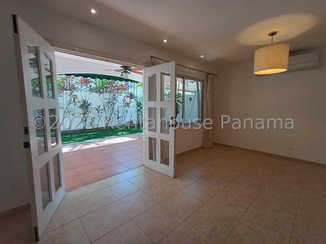 Empty bedroom with large window, AC, blinds and tile flooring in Costa del Este Panama