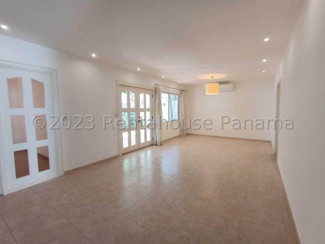 Spacious empty living room with large glass doors, tile flooring in Costa del Este Panama