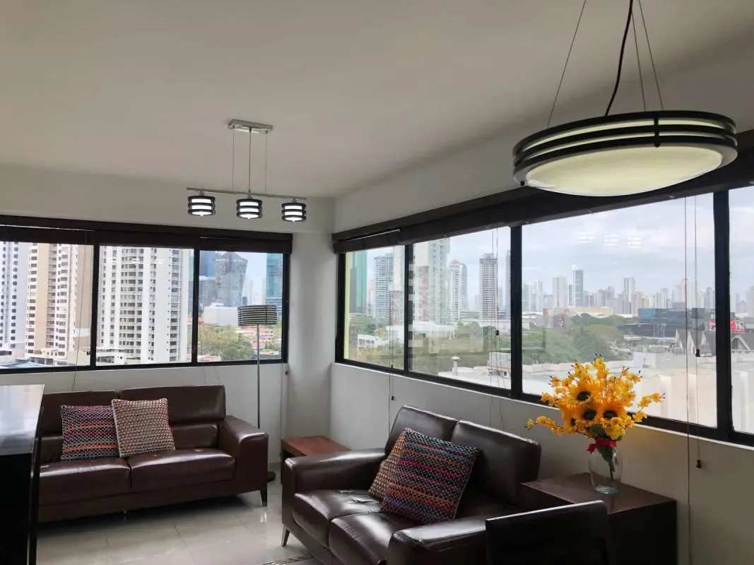 Bright living room with leather sofa large windows Marbella Panama PH Royal Center Apartment for sale