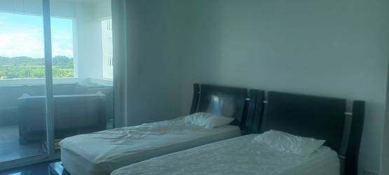 Modern bedroom with sliding glass doors balcony overlooking ocean Founders Tower Panama