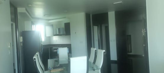 Modern open kitchen with glass dining table appliances Playa Blanca Founders Tower Panama