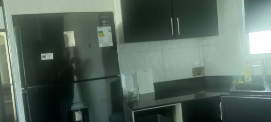 Modern kitchen with black cabinets stove oven range hood Playa Blanca Founders Tower