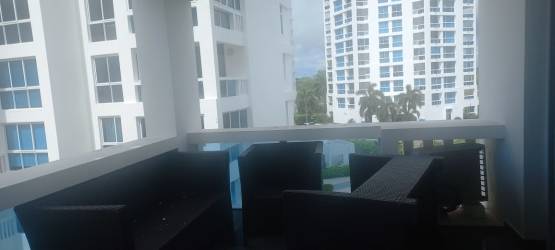 Balcony with black wicker table chairs view over resort Playa Blanca Panama