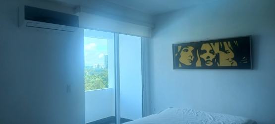 Bedroom features large sliding glass doors to balcony, ocean views Founders Tower Panama