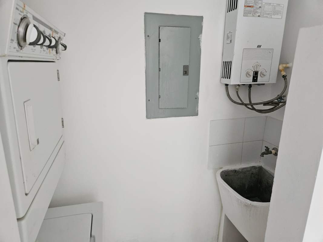 Main entrance of Green Park condo Condado del Rey with landscaping and security gate