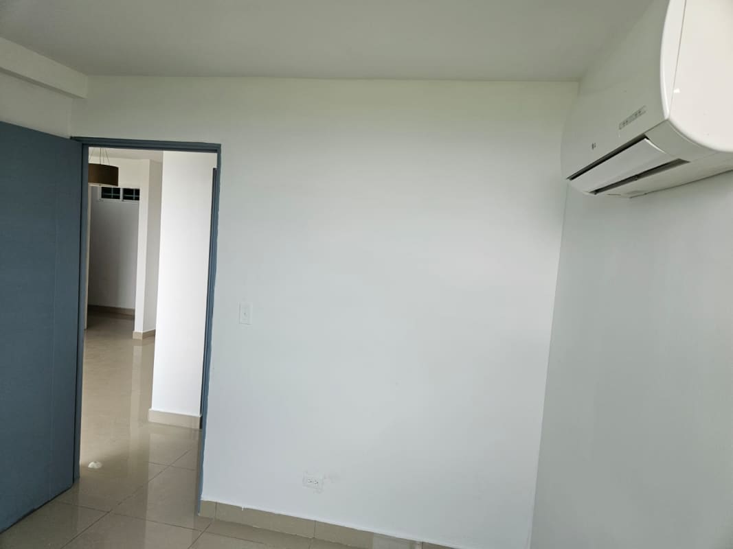 Covered patio with tables and benches next to gardens at PH Green Park