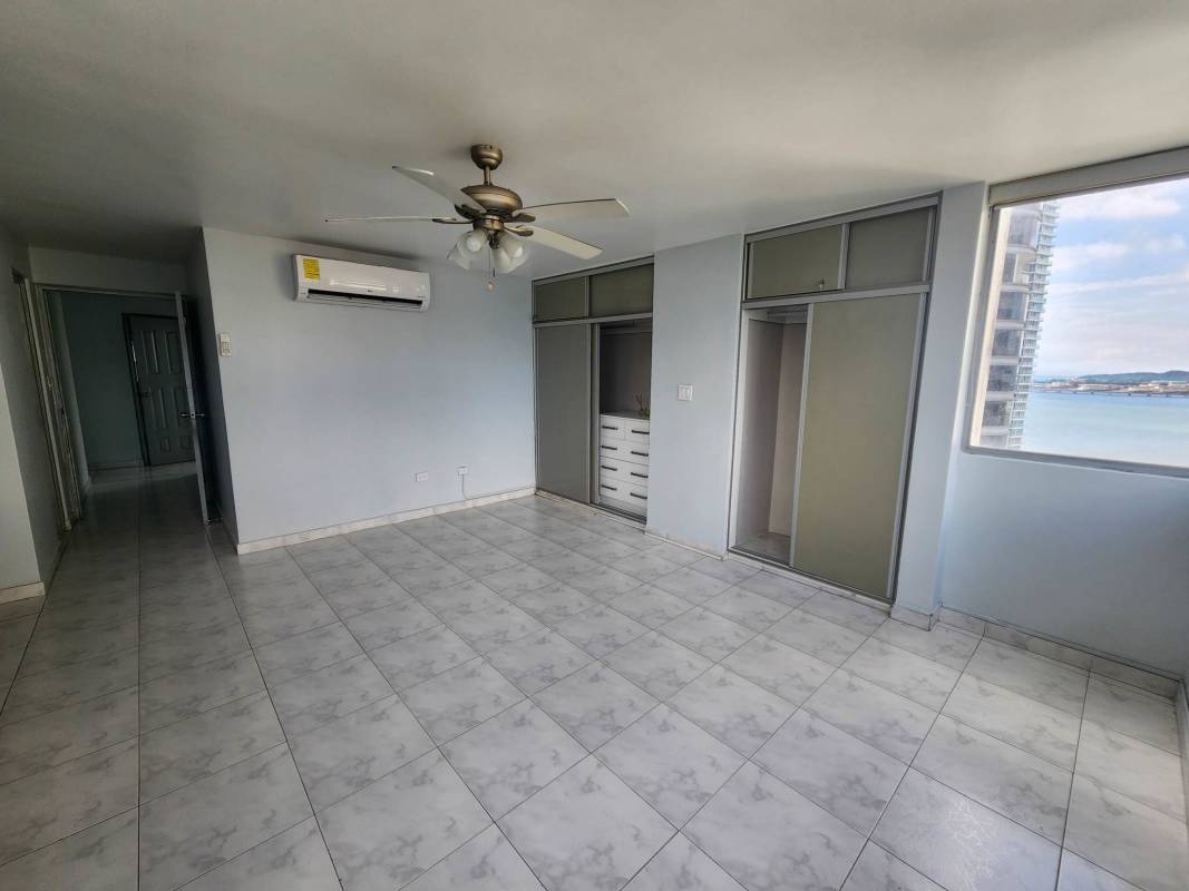 Bedroom with built-in closet, large window, ocean view in PH Paitilla Tower Panama