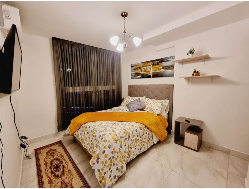 Compact modern kitchen with stainless steel appliances and quartz countertops in PH BICSA Financial Center Panama City