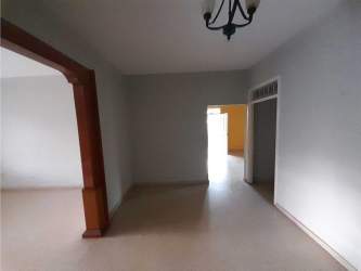 Bedroom with ceiling fan, split air conditioning and large window in family house for sale Chitré Panama