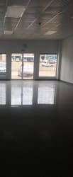Open interior of commercial retail unit with large windows tiled flooring at Plaza LG Vista Alegre Panama