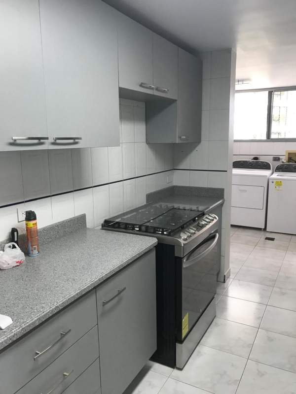 Grey cabinets, granite countertops and integrated laundry in PH Punta Paitilla Panama