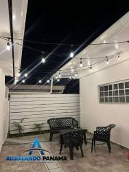 Private outdoor patio area in residence with string lights, seating, privacy fencing Panama