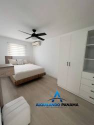 Cozy dining nook with round table, pendant light, white brick wall in Panama Pacifico rental home