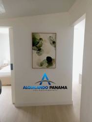 Modern hallway in rental house at Residencial Howard with white walls and artwork Panama