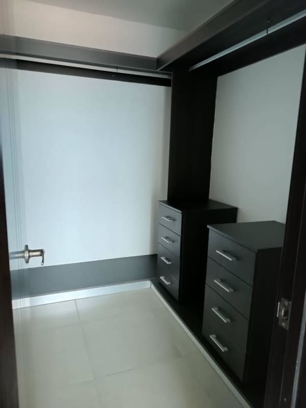 Modern walk-in closet with built-in cabinetry ample storage Country Heights Panama