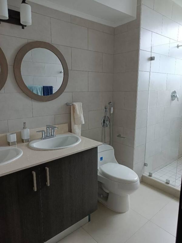 Stylish bathroom with double sink vanity and glass shower Panama City