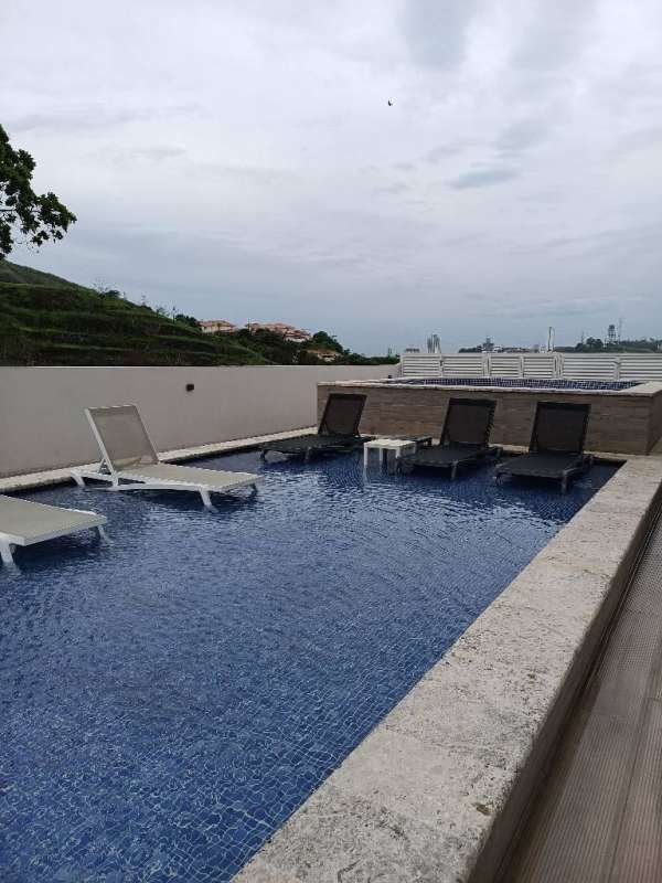 Rooftop swimming pool with lounge chairs, city skyline view Country Heights Altos de Panama