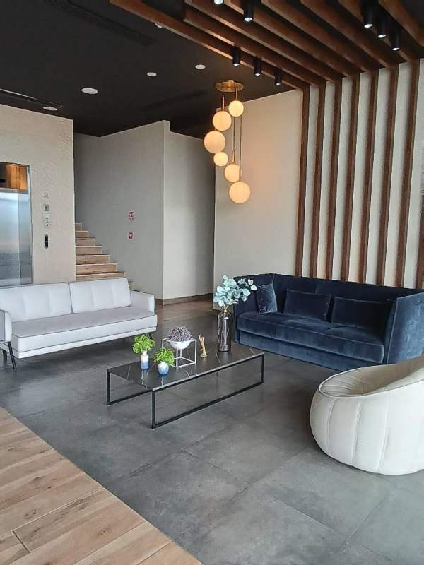 Stylish condominium lobby with elegant sofas and pendant lights