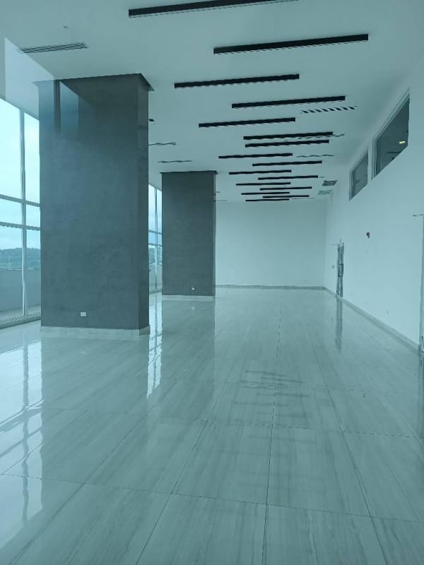 Open commercial area inside Country Heights complex with pillar supports and large windows