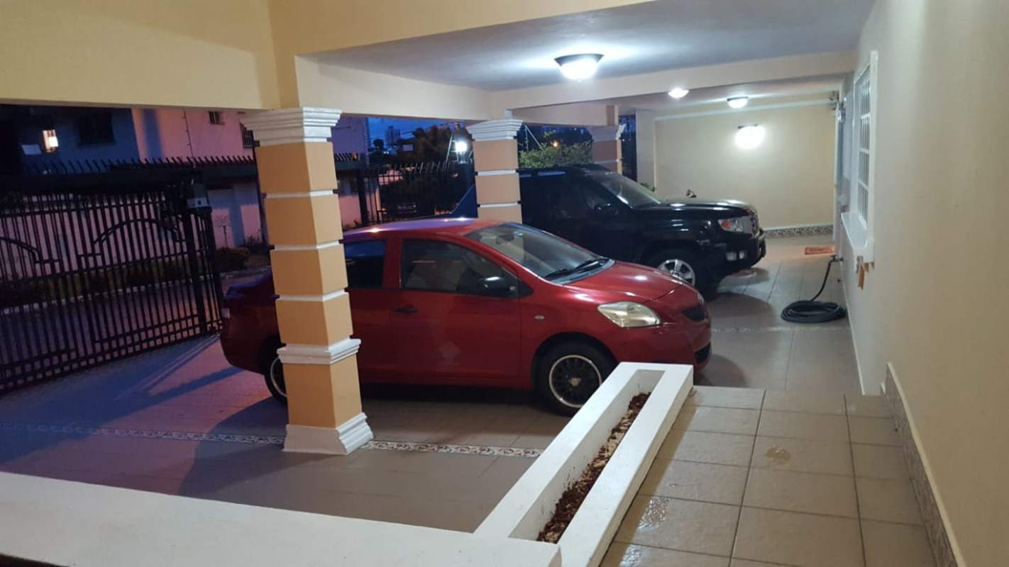 Three-car covered parking with columns and tiles gated entrance in Betania Panama