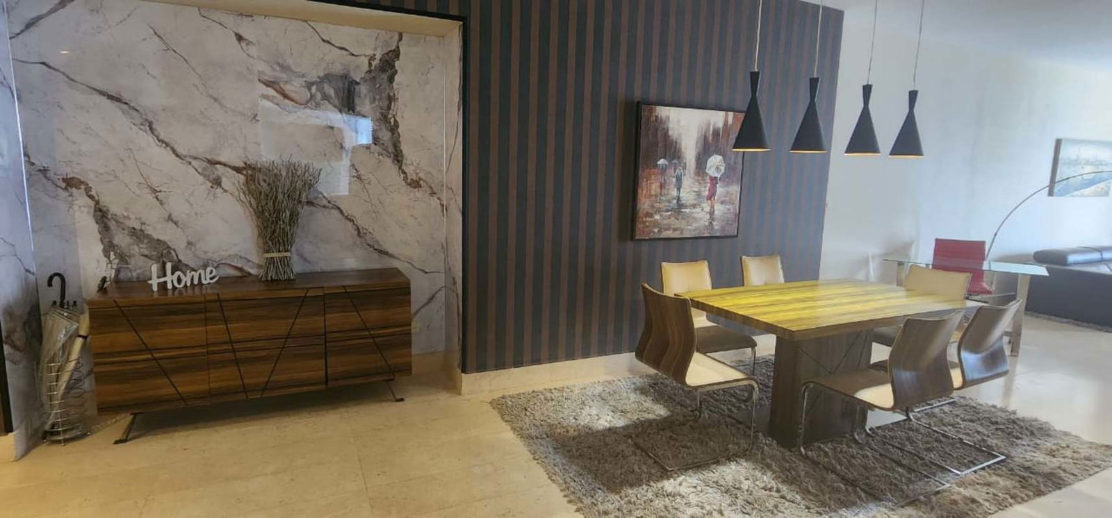 Living room with marble TV wall and floor-to-ceiling windows PH Yoo Panama