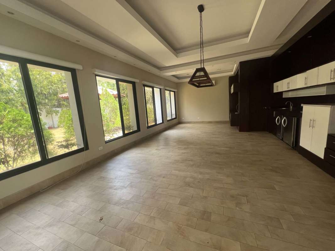 Bright modern kitchen with marble countertops and stainless appliances in luxury house Costa del Este