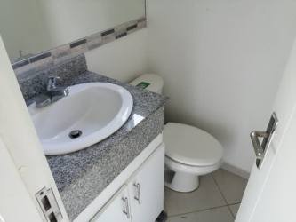 Small modern bathroom with granite countertop, ceramic sink, and tile wall in PH Santillana Arraiján Panama